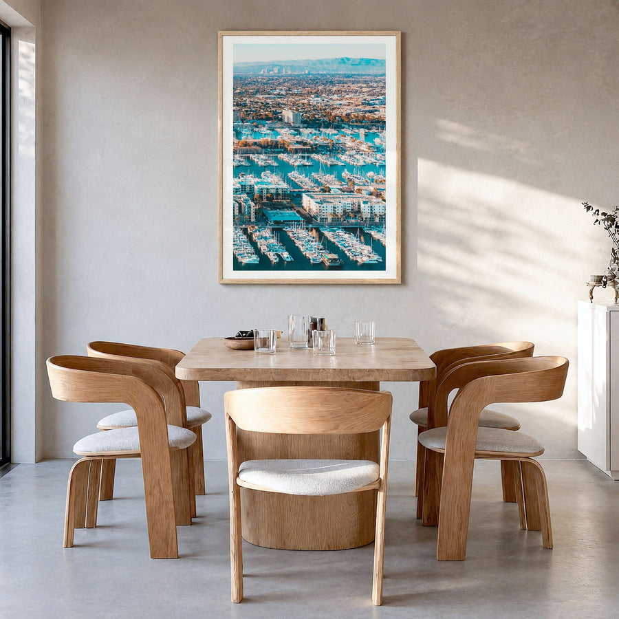 Marina del Rey Photo Poster in a natural wood frame, hanging in a dining room, white border