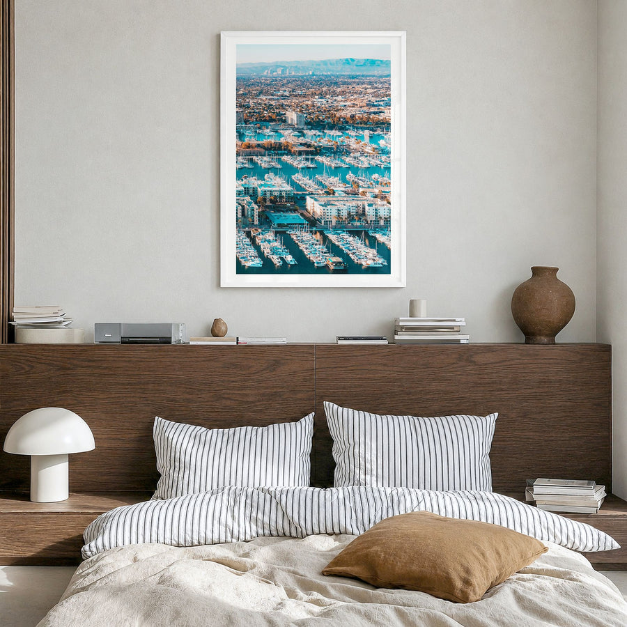 Marina del Rey Photo Poster in a white wood frame, hanging in a bedroom, white border
