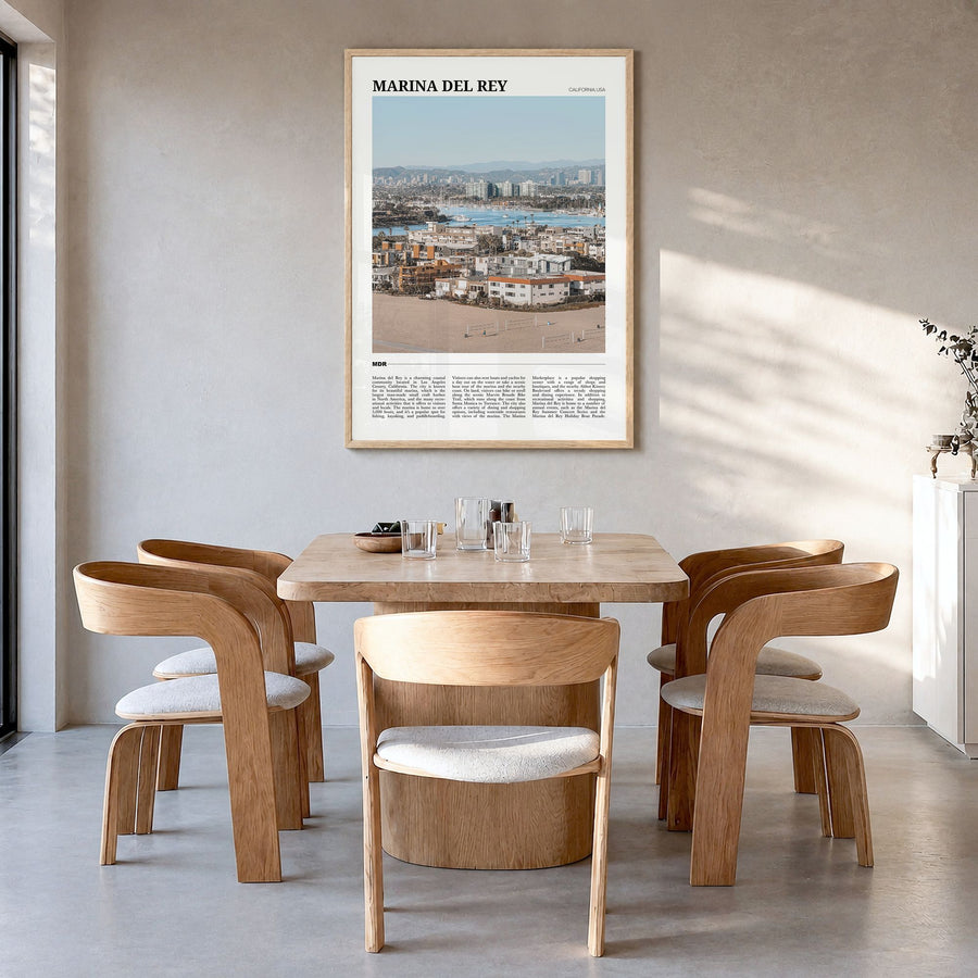 Marina del Rey Travel Poster in a natural wood frame, hanging in a dining room