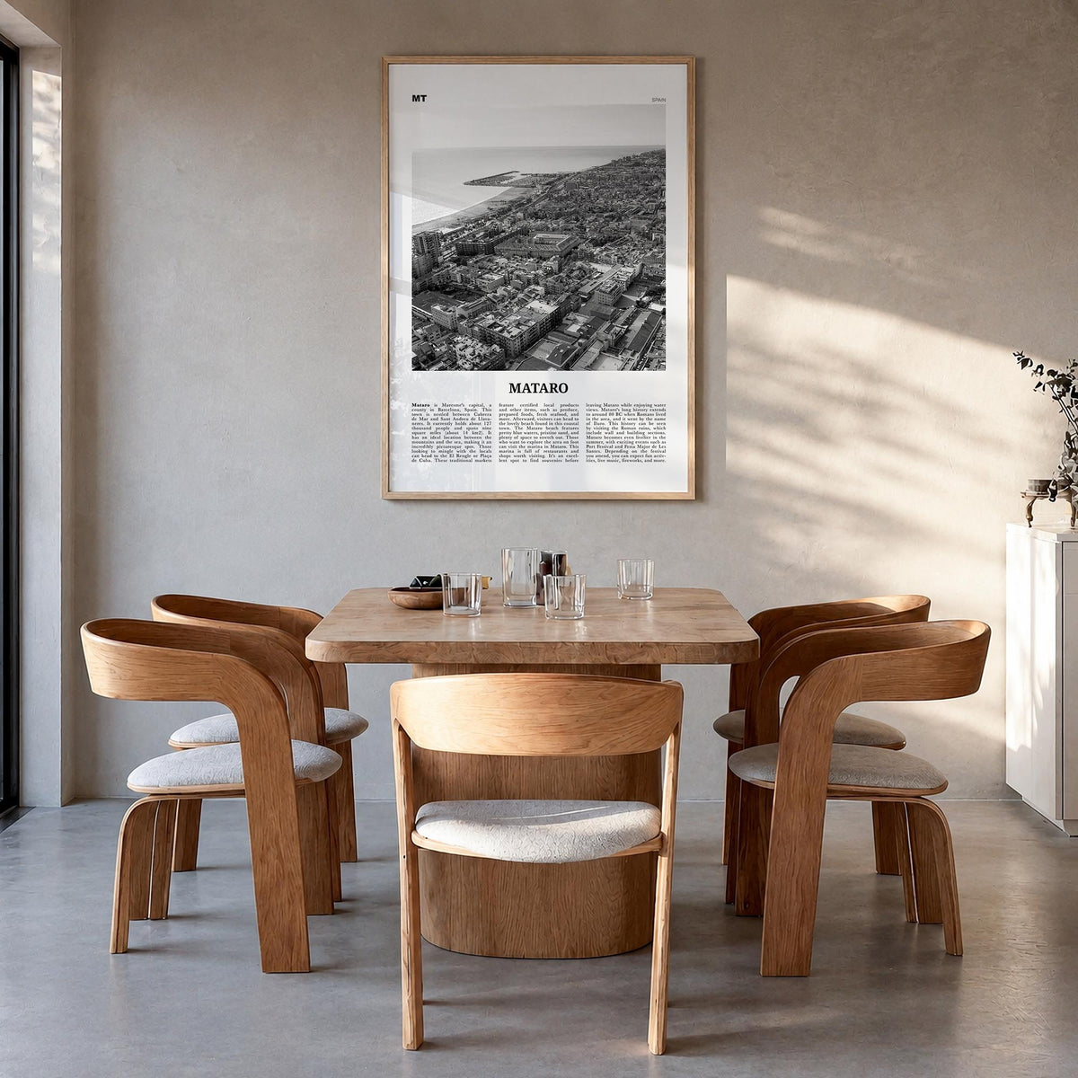 Mataró black & white newspaper poster of Spain – vertical wall art in natural wood frame, hanging on wall