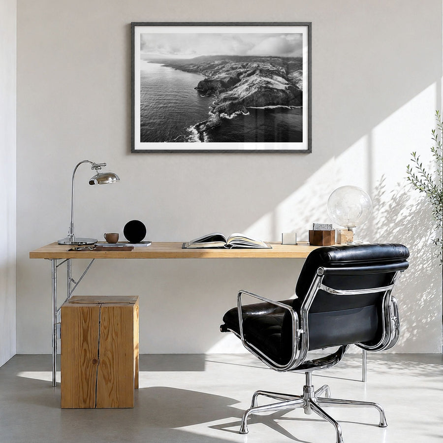 Maui Photo Poster in a black wood frame, hanging in a bright home office, white border
