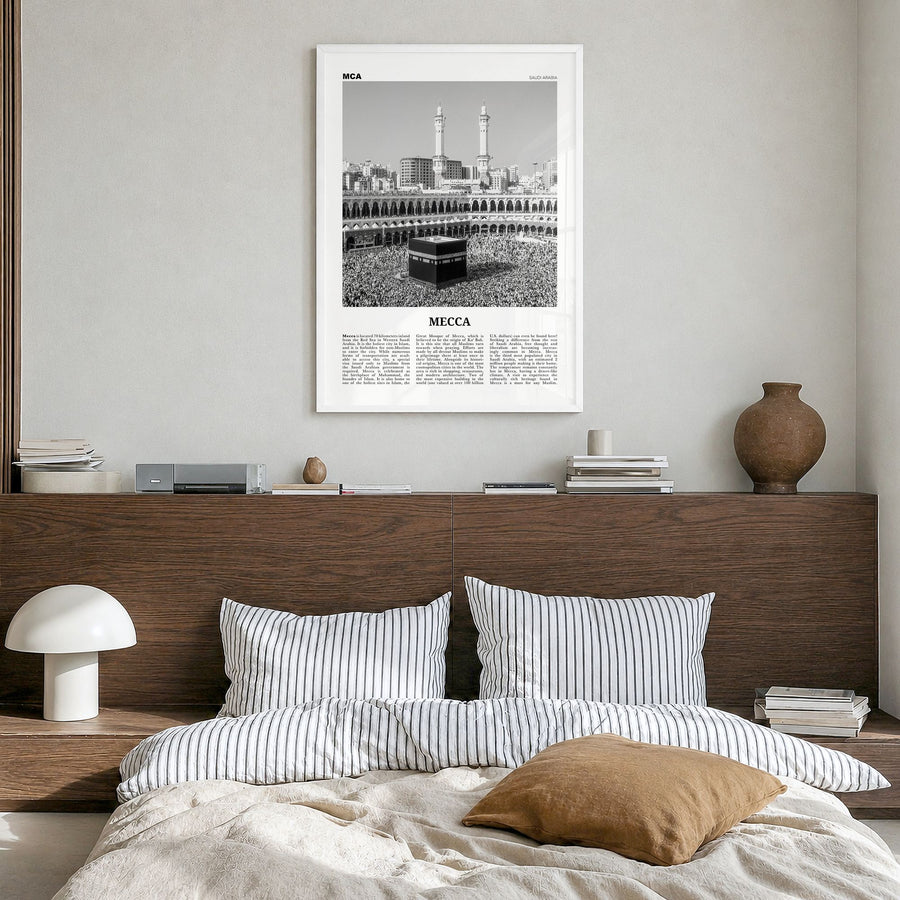 Mecca Newspaper Poster in a white wood frame, hanging in a bedroom