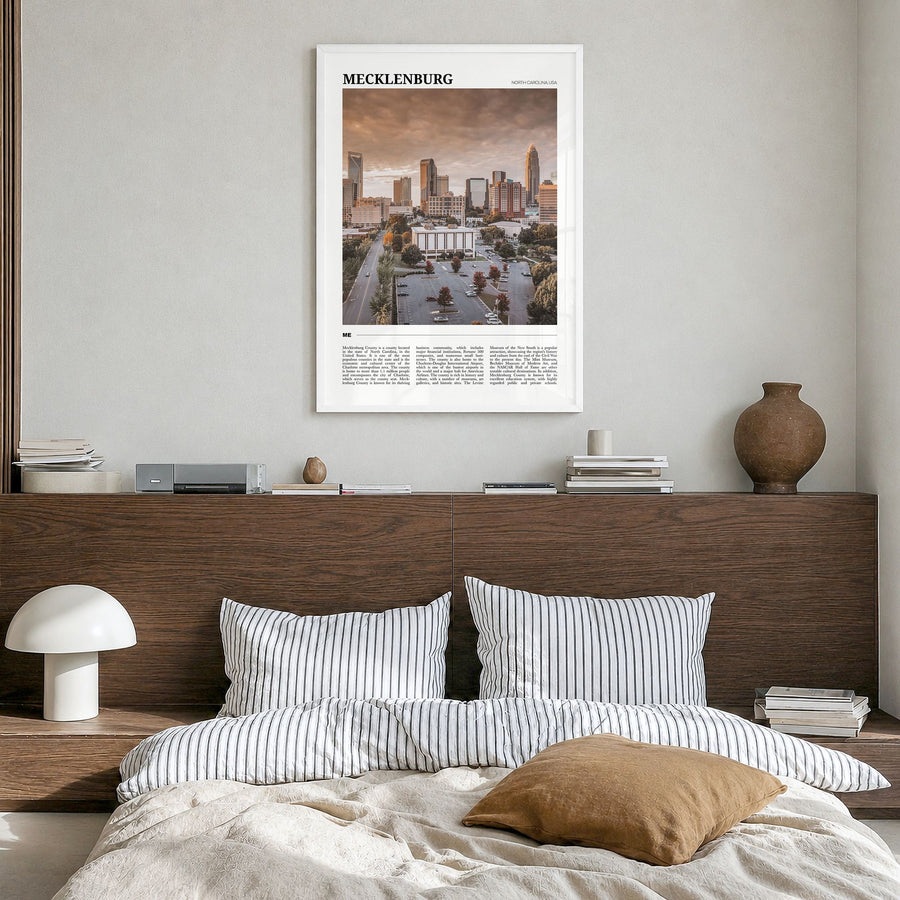 Mecklenburg County Travel Poster in a white wood frame, hanging in a bedroom