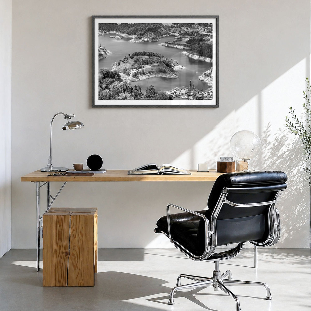 Medellín Photo Poster in a black wood frame, hanging in a bright home office, white border