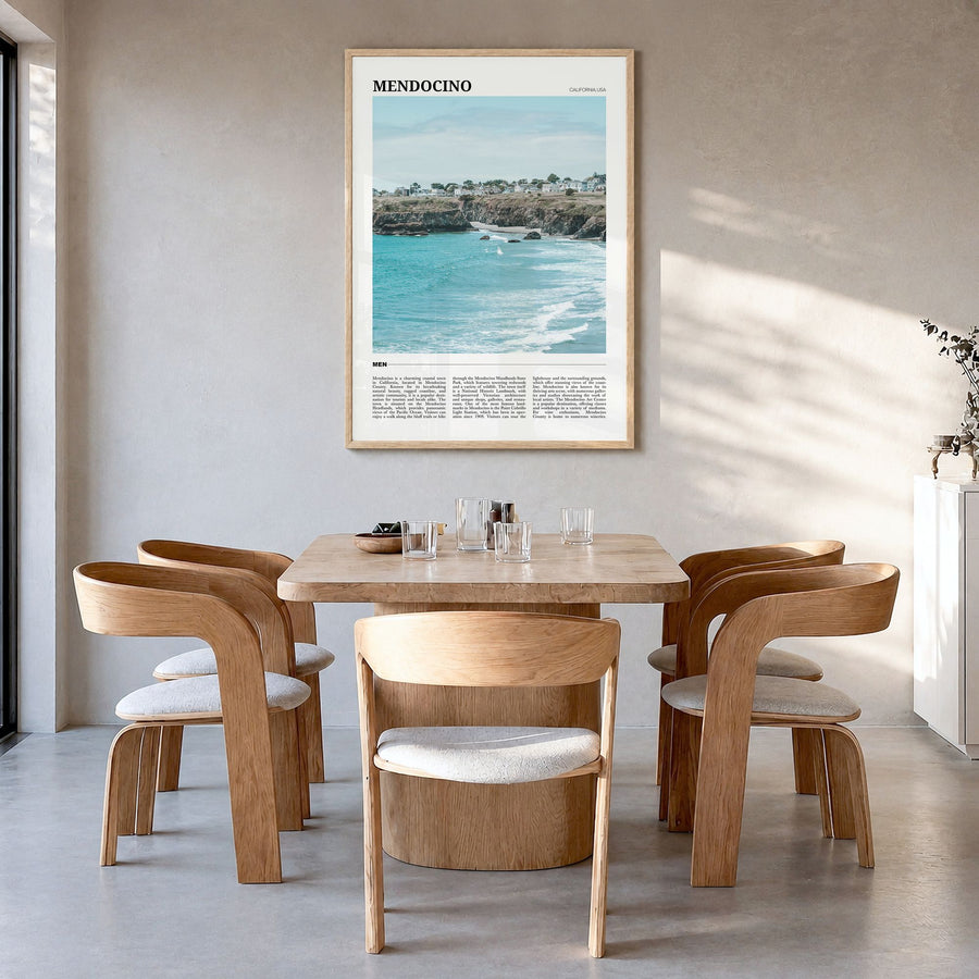 Mendocino Travel Poster in a natural wood frame, hanging in a dining room
