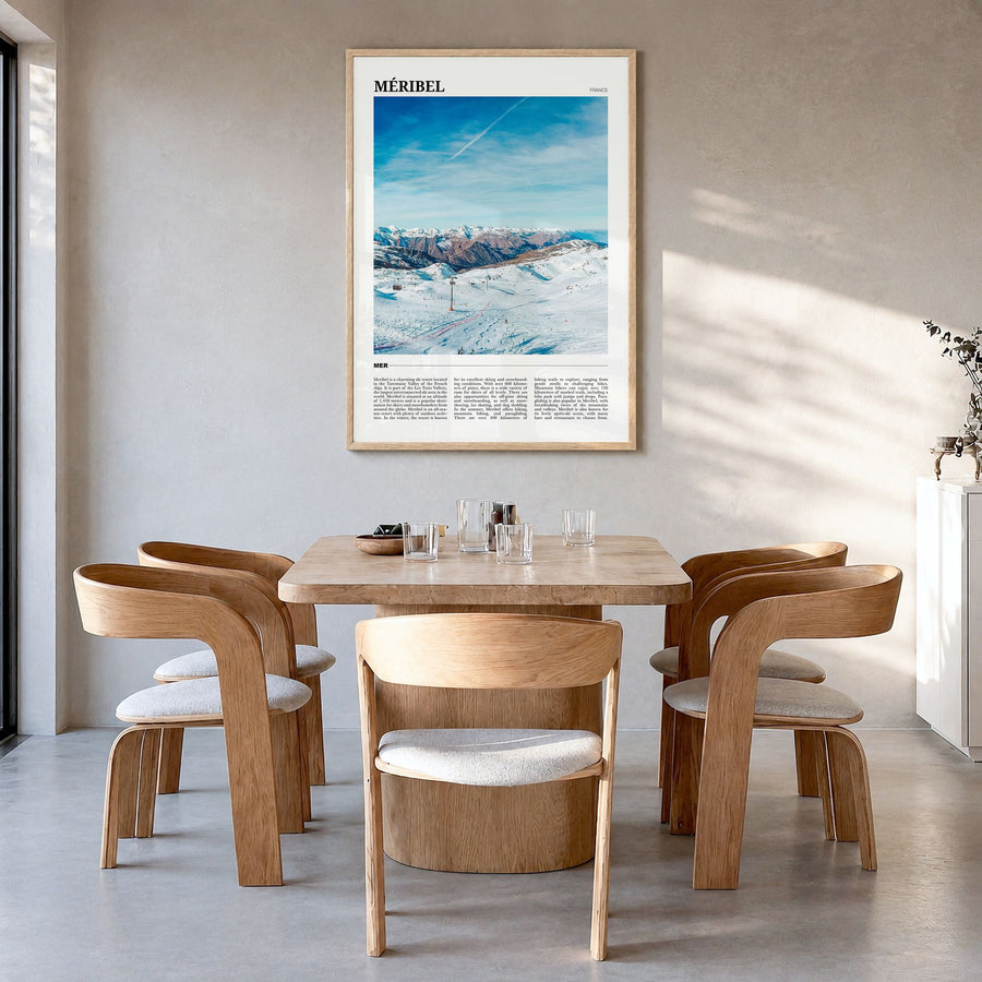 Méribel Travel Poster in a natural wood frame, hanging in a dining room
