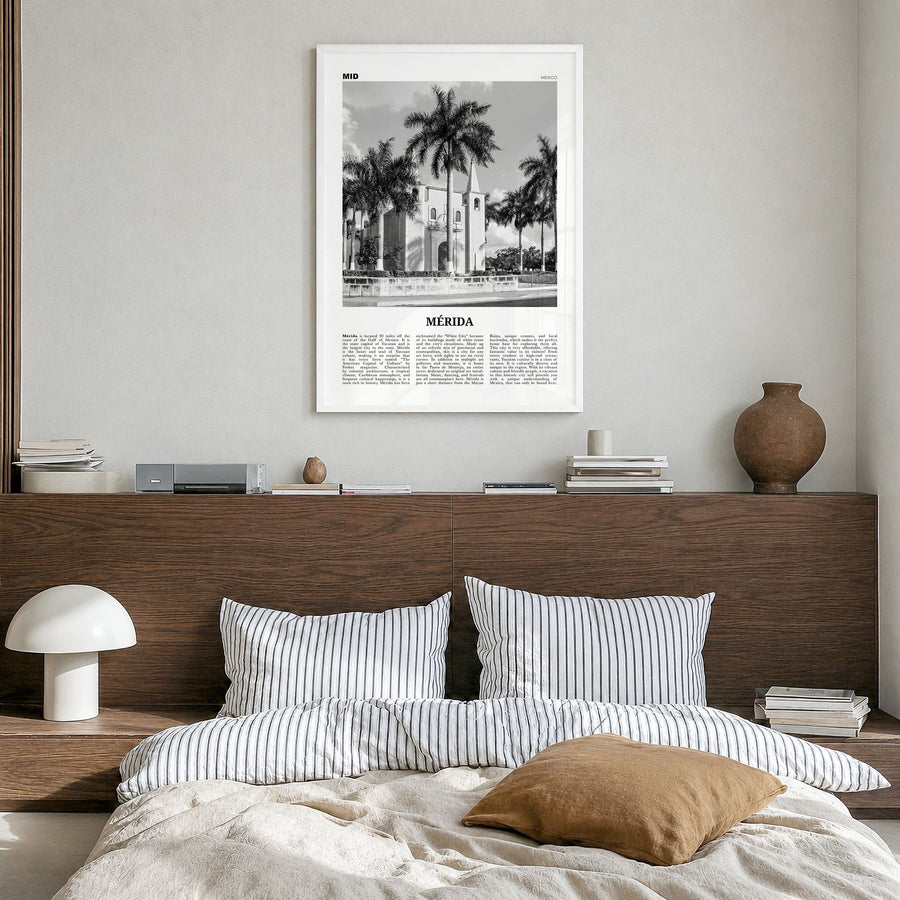 Mérida Newspaper Poster in a white wood frame, hanging in a bedroom