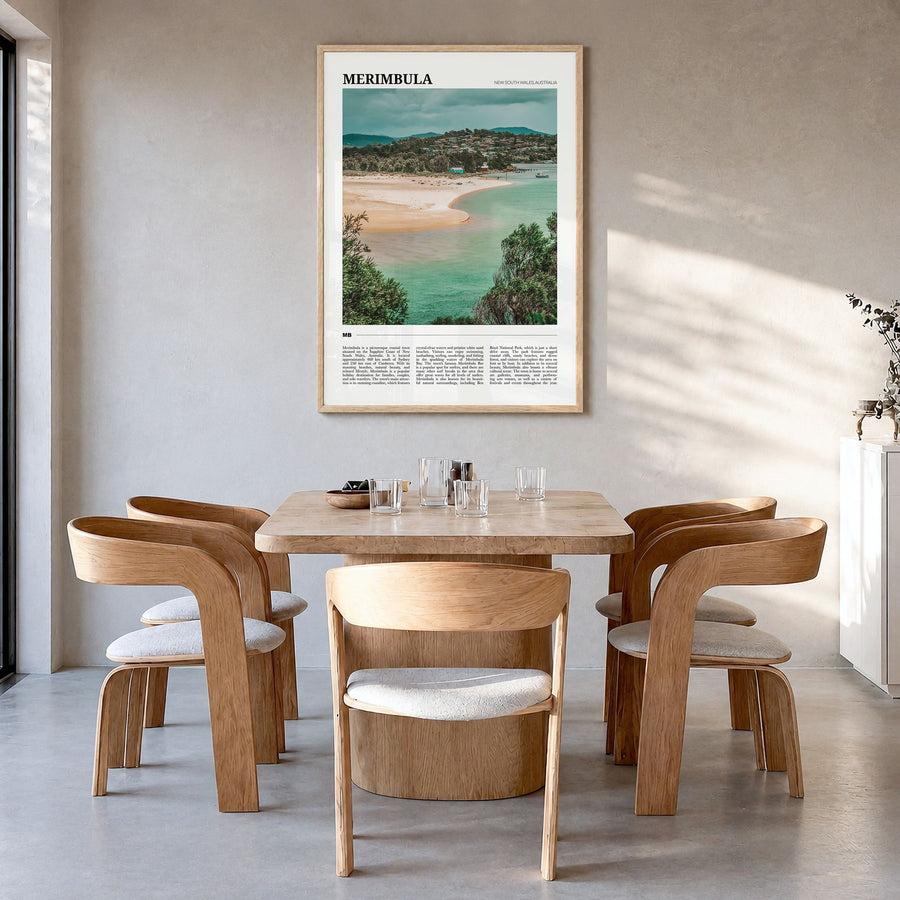 Merimbula Travel Poster in a natural wood frame, hanging in a dining room