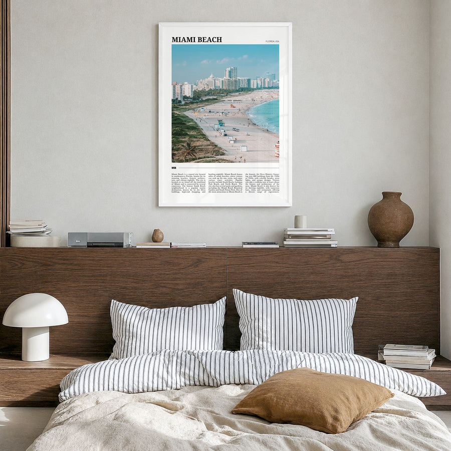 Miami Beach Travel Poster in a white wood frame, hanging in a bedroom