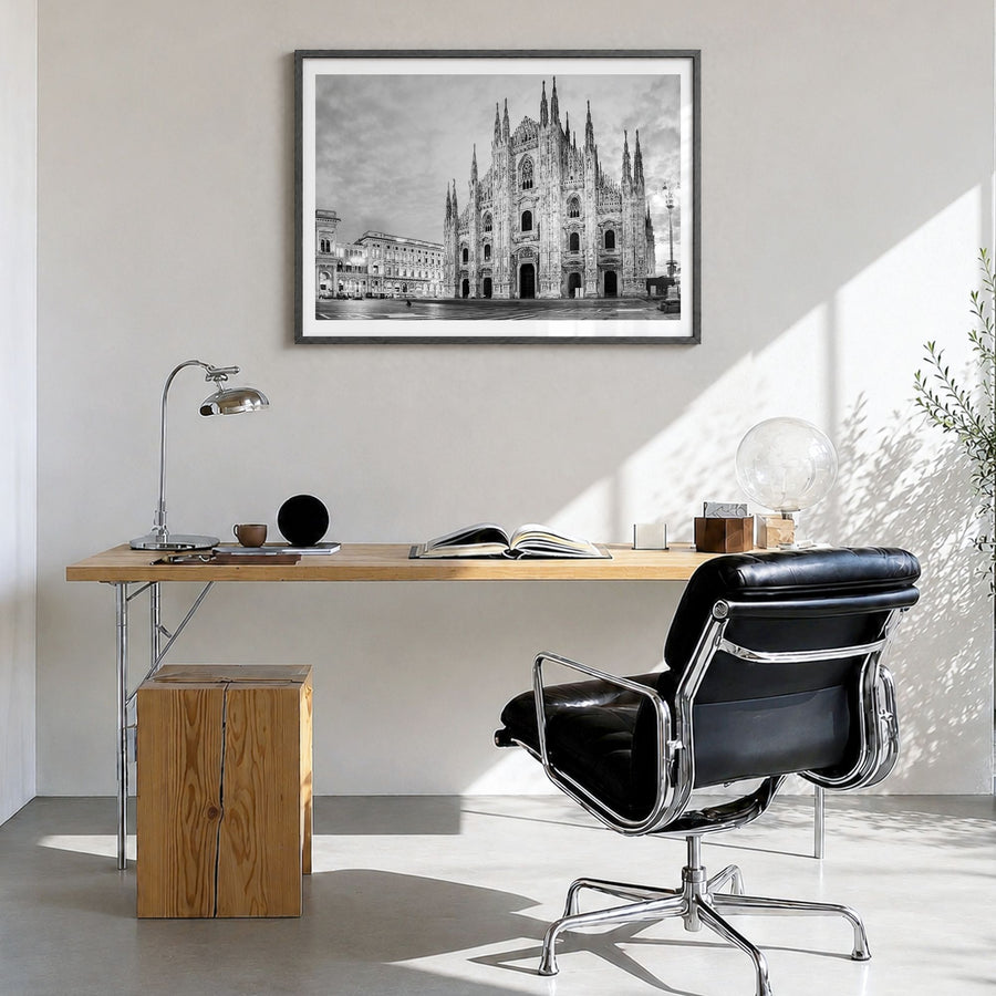 Milan Photo Poster in a black wood frame, hanging in a bright home office, white border