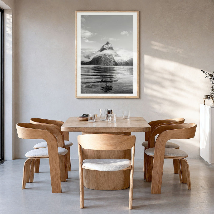 Milford Sound Photo Poster in a natural wood frame, hanging in a dining room, white border