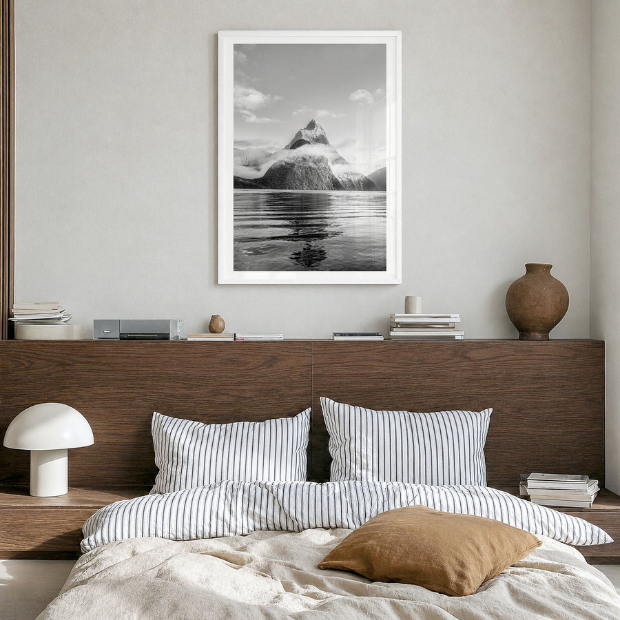 Milford Sound Photo Poster in a white wood frame, hanging in a bedroom, white border