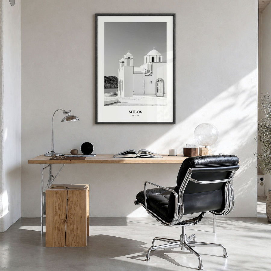 Milos Classic Poster in a black wood frame, hanging in a bright home office