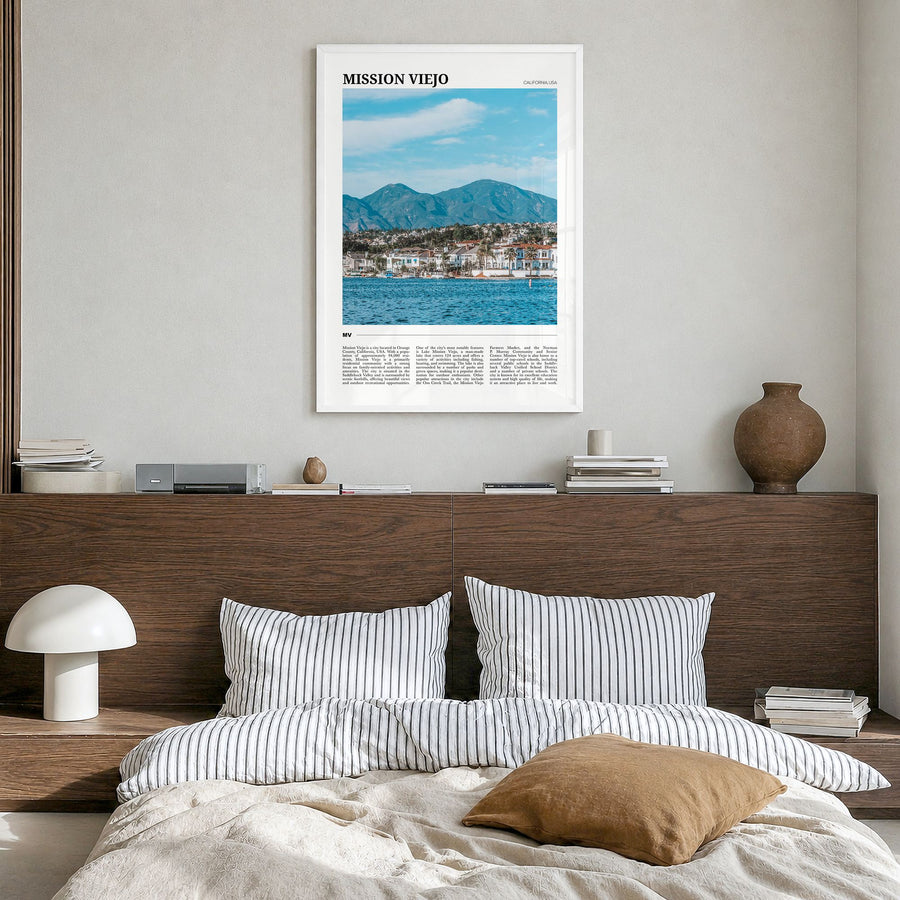 Mission Viejo Travel Poster in a white wood frame, hanging in a bedroom