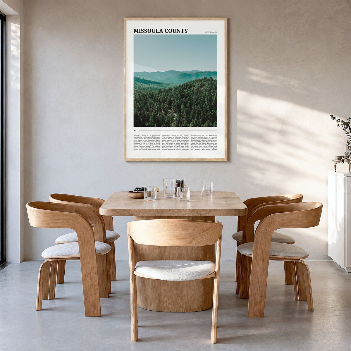 Missoula County Travel Poster in a natural wood frame, hanging in a dining room