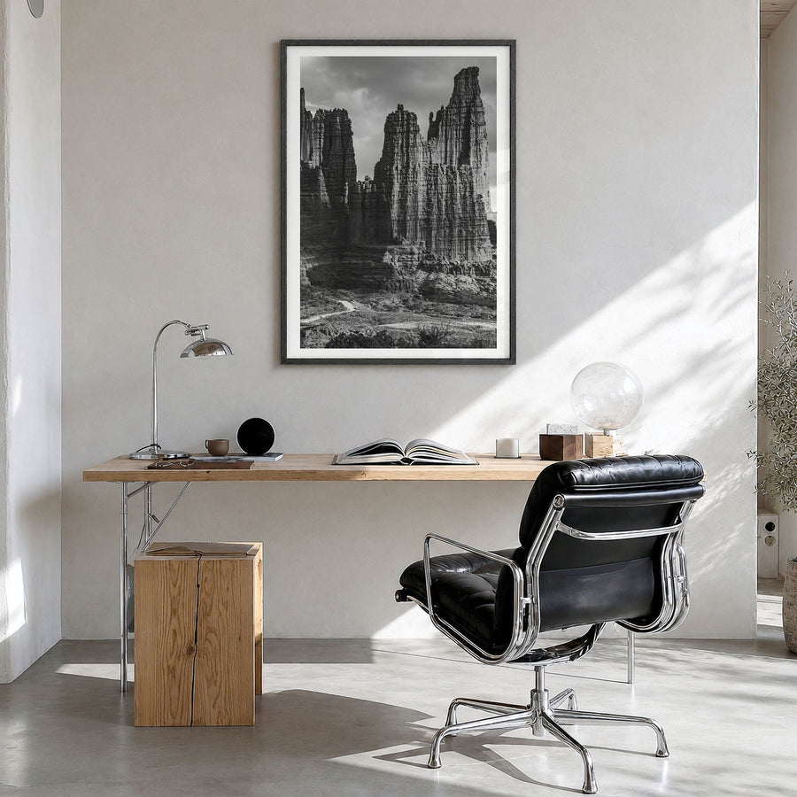 Moab Photo Poster in a black wood frame, hanging in a bright home office, white border