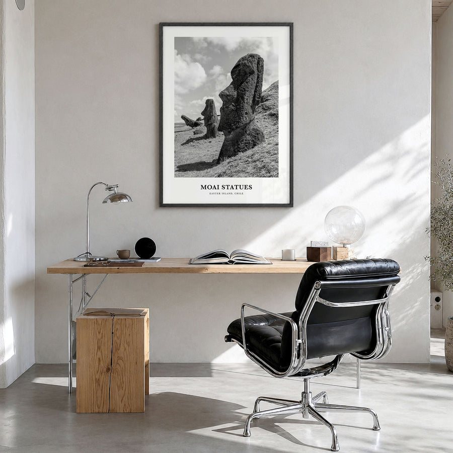 Moai Statues Classic Poster in a black wood frame, hanging in a bright home office