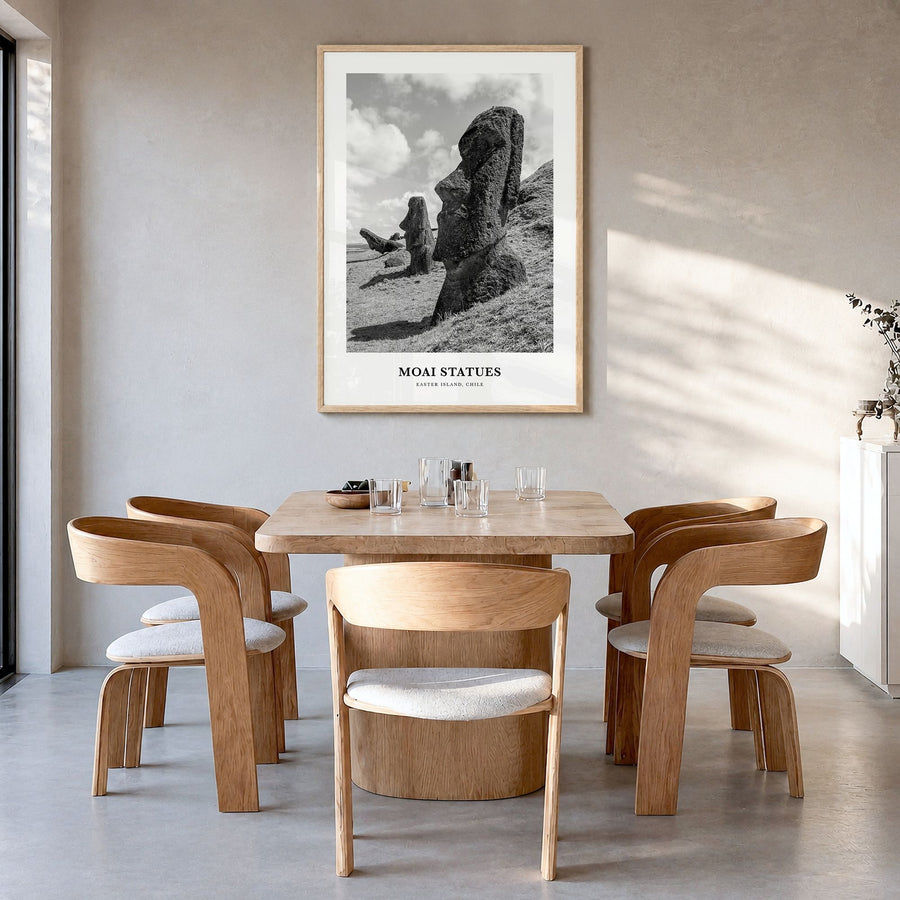 Moai Statues Classic Poster in a natural wood frame, hanging in a dining room