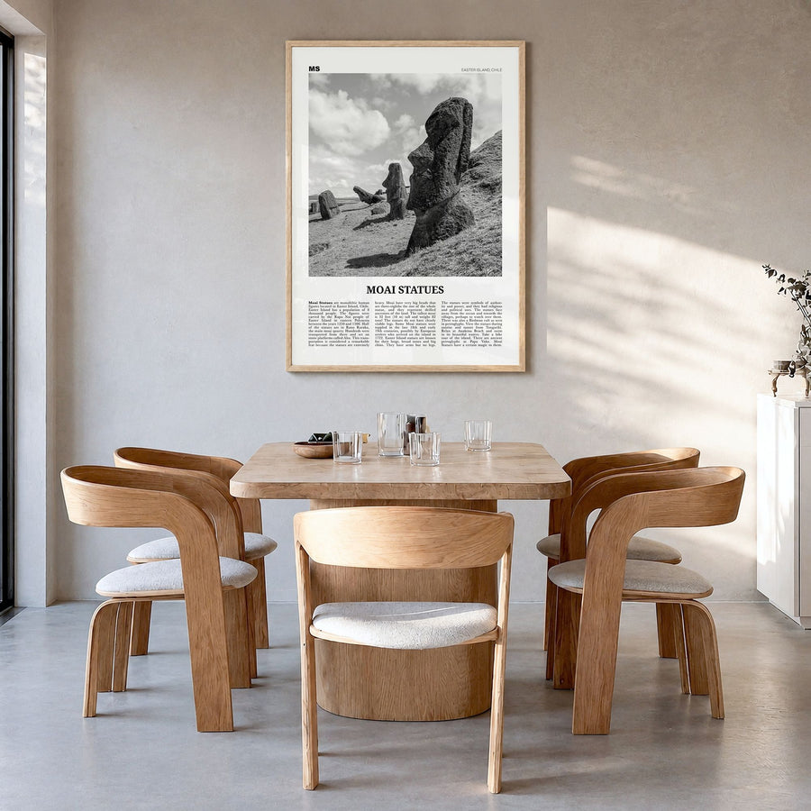 Moai Statues Newspaper Poster in a natural wood frame, hanging in a dining room