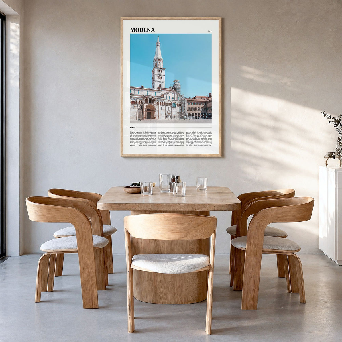 Modena Travel Poster in a natural wood frame, hanging in a dining room