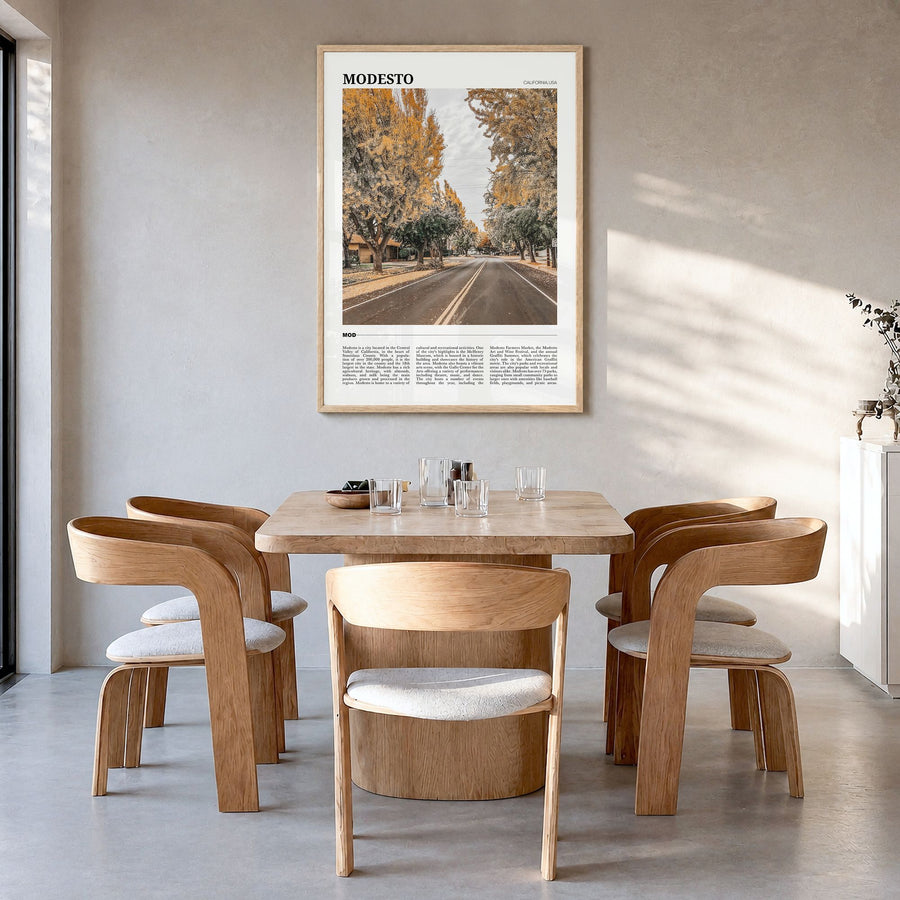 Modesto Travel Poster in a natural wood frame, hanging in a dining room