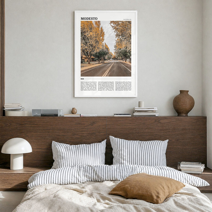 Modesto Travel Poster in a white wood frame, hanging in a bedroom