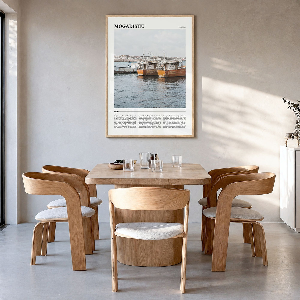Mogadishu Travel Poster in a natural wood frame, hanging in a dining room
