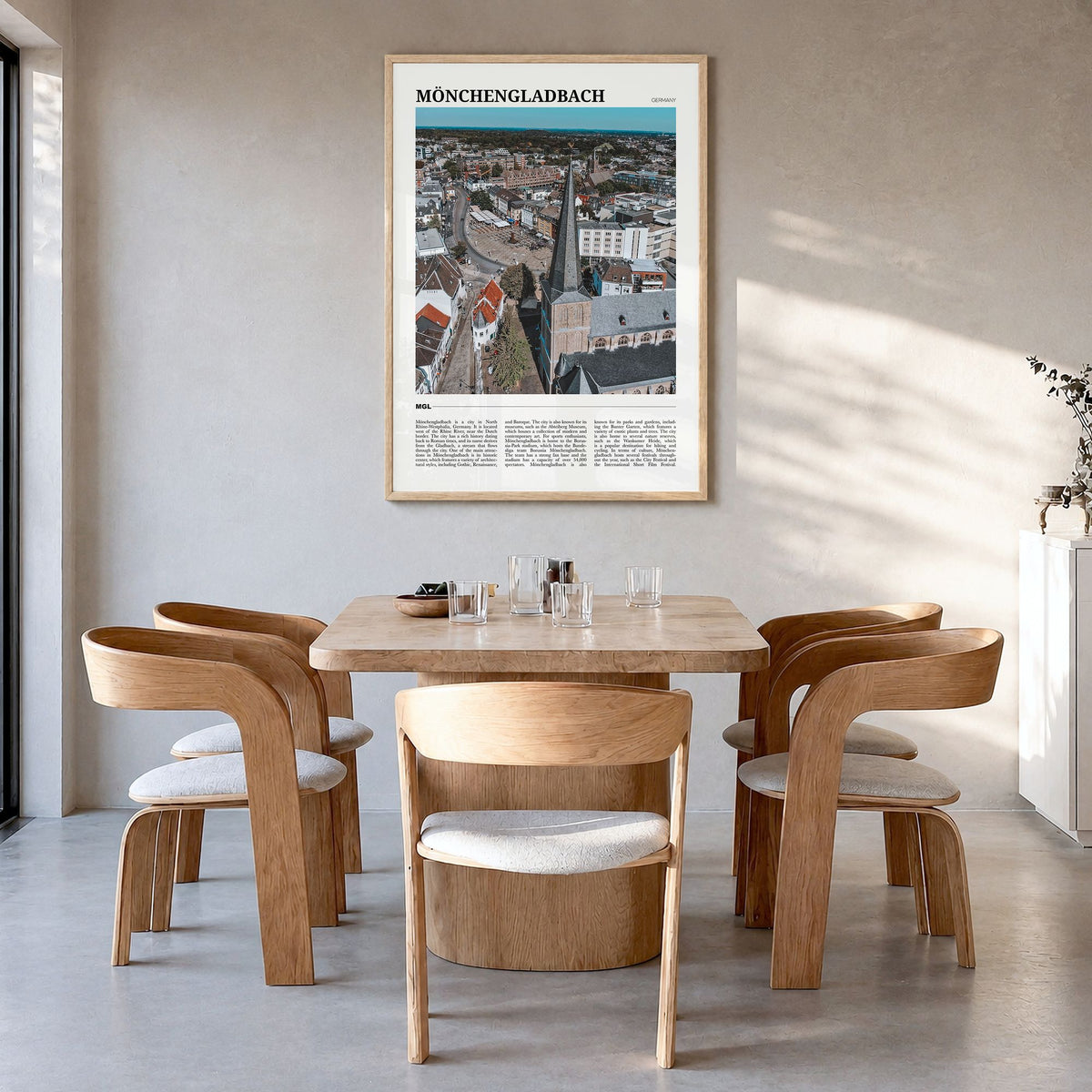 Mönchengladbach Travel Poster in a natural wood frame, hanging in a dining room
