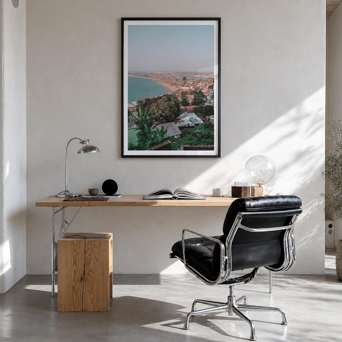 Monrovia colorful photo poster of Liberia – vertical wall art in black wood frame with white border, hanging on wall