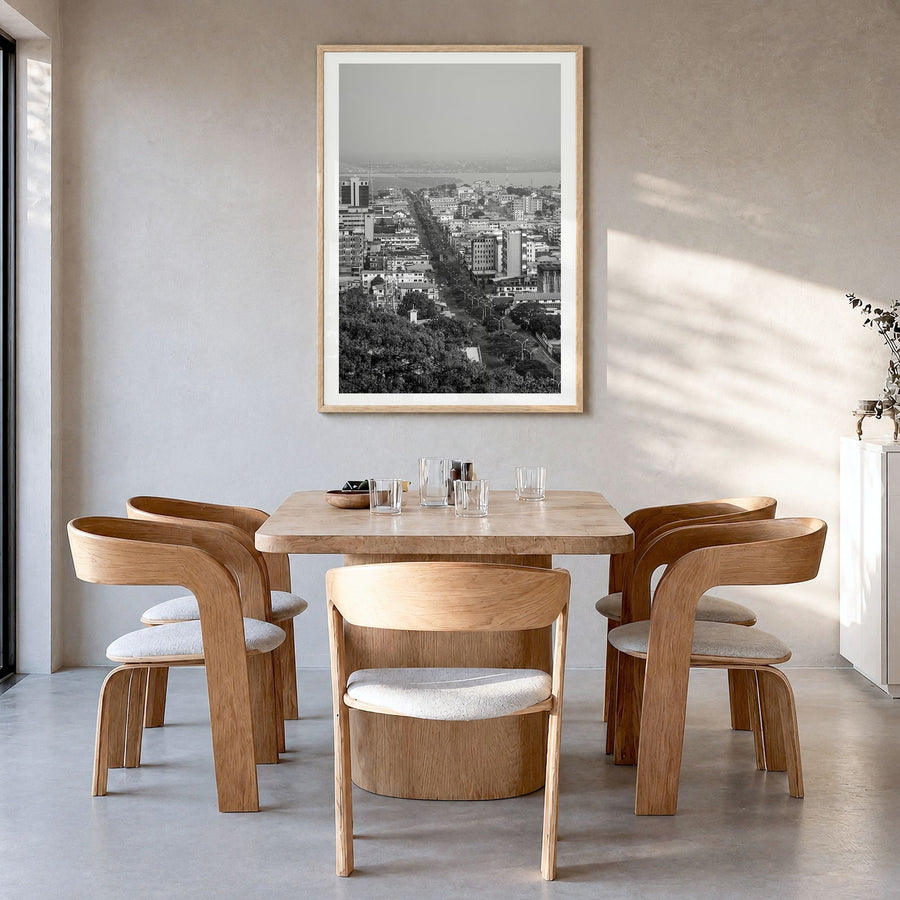 Monrovia Photo Poster in a natural wood frame, hanging in a dining room, white border