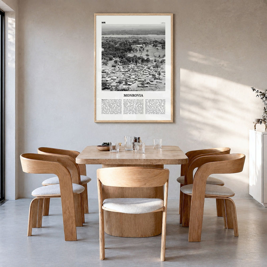 Monrovia Newspaper Poster in a natural wood frame, hanging in a dining room