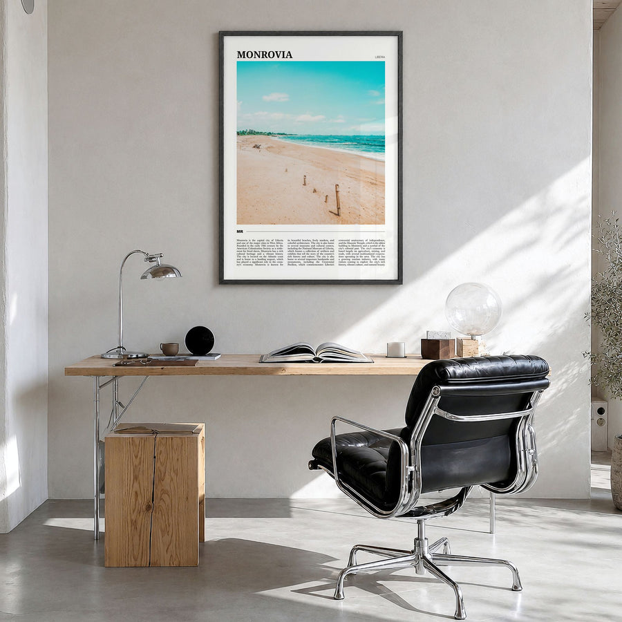 Monrovia Travel No 1 Poster in a black wood frame, hanging in a bright home office