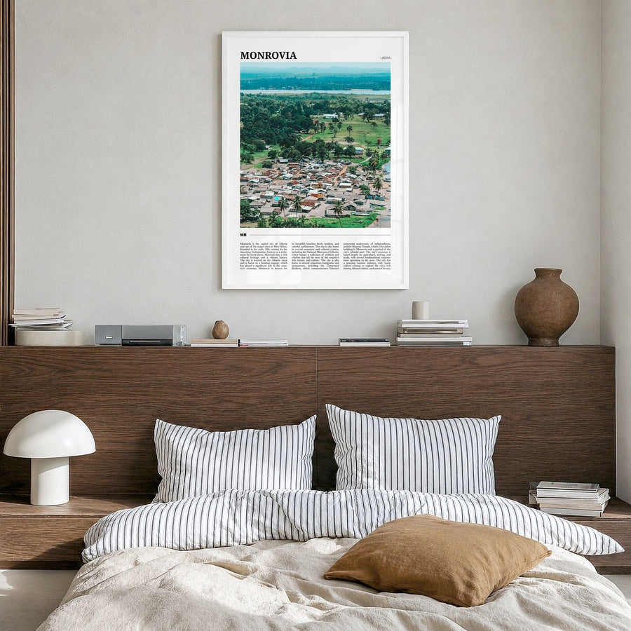 Monrovia Travel No 2 Poster in a white wood frame, hanging in a bedroom