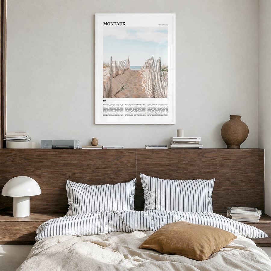 Montauk Travel Poster in a white wood frame, hanging in a bedroom