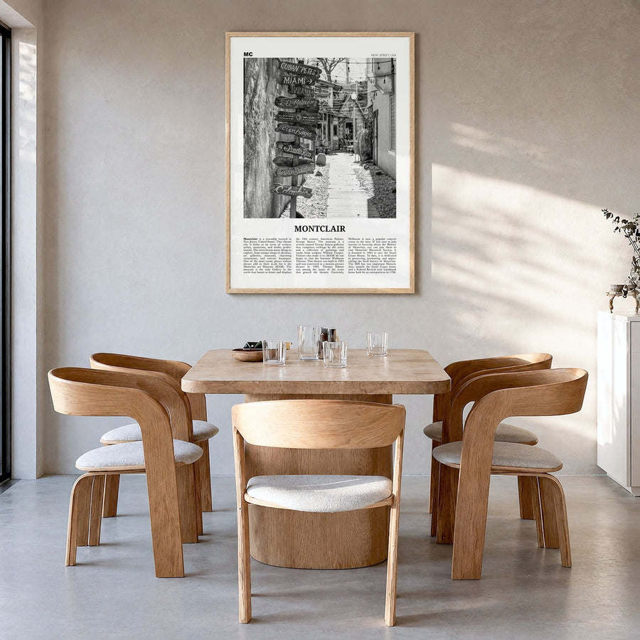 Montclair Newspaper Poster in a natural wood frame, hanging in a dining room