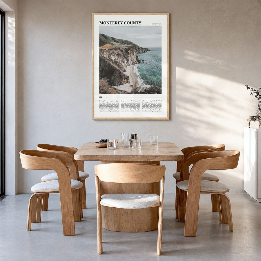 Monterey County Travel Poster in a natural wood frame, hanging in a dining room