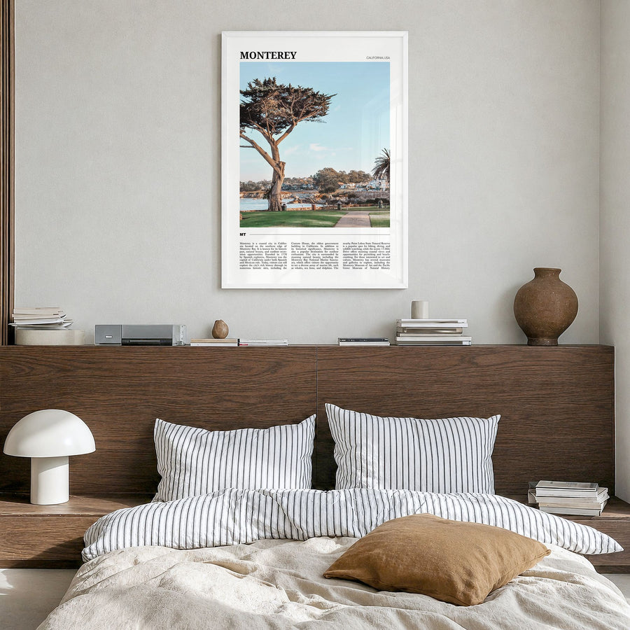 Monterey, California Travel Poster in a white wood frame, hanging in a bedroom