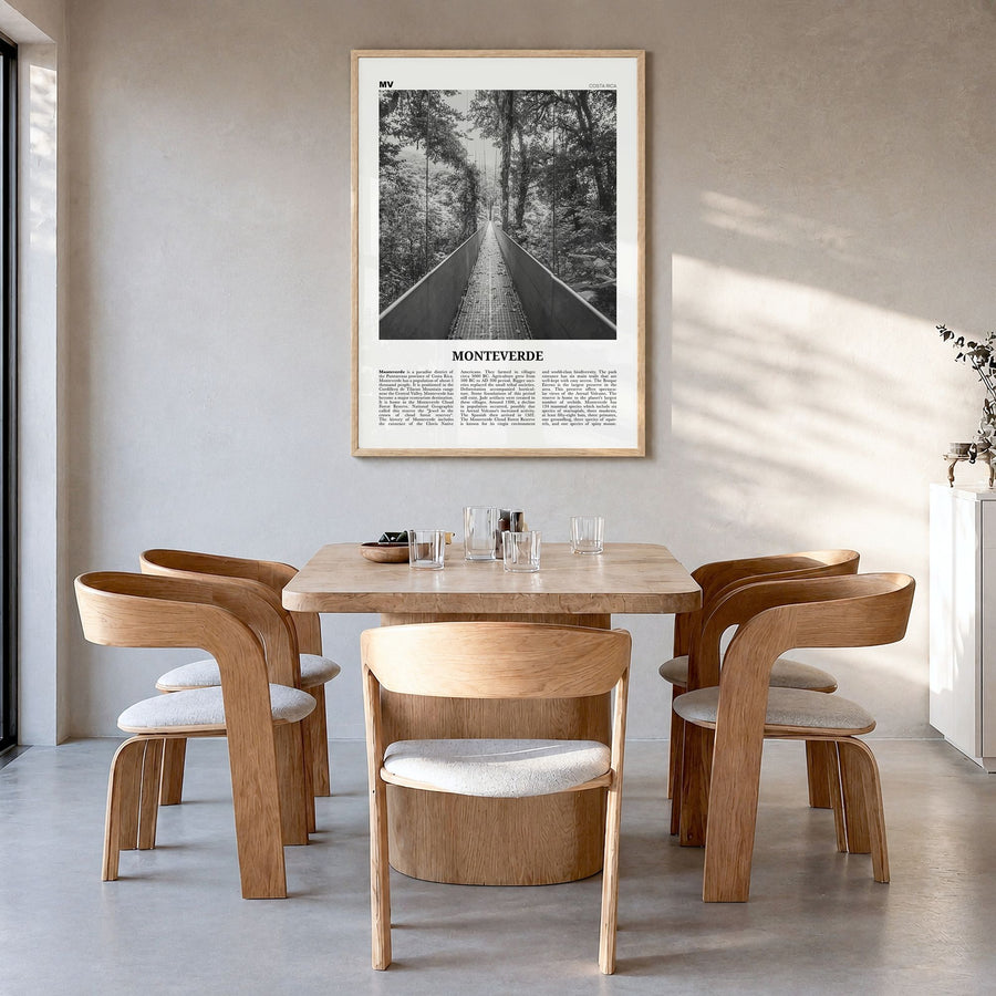Monteverde Newspaper Poster in a natural wood frame, hanging in a dining room