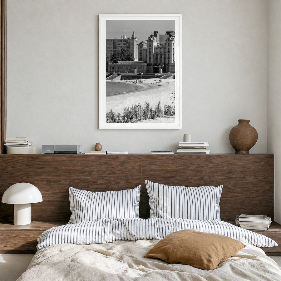 Montevideo Photo Poster in a white wood frame, hanging in a bedroom, white border
