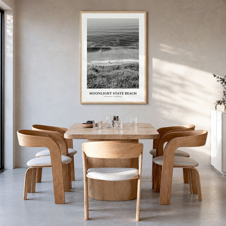 Moonlight State Beach Classic Poster in a natural wood frame, hanging in a dining room
