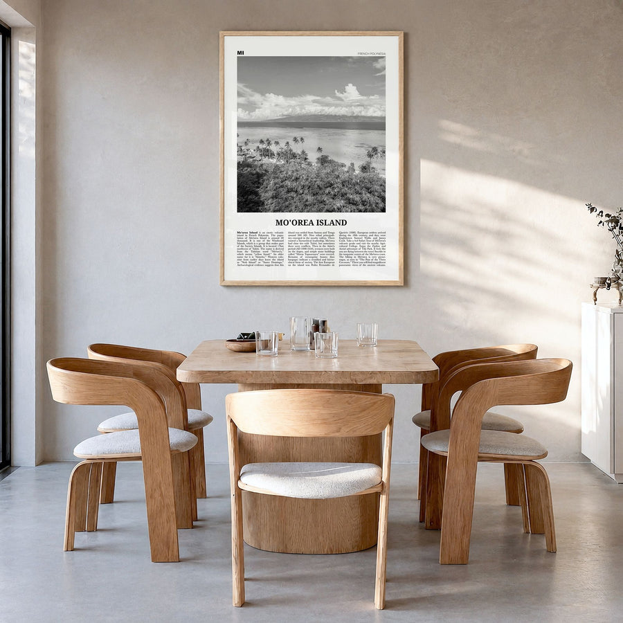 Moorea Island Newspaper Poster in a natural wood frame, hanging in a dining room