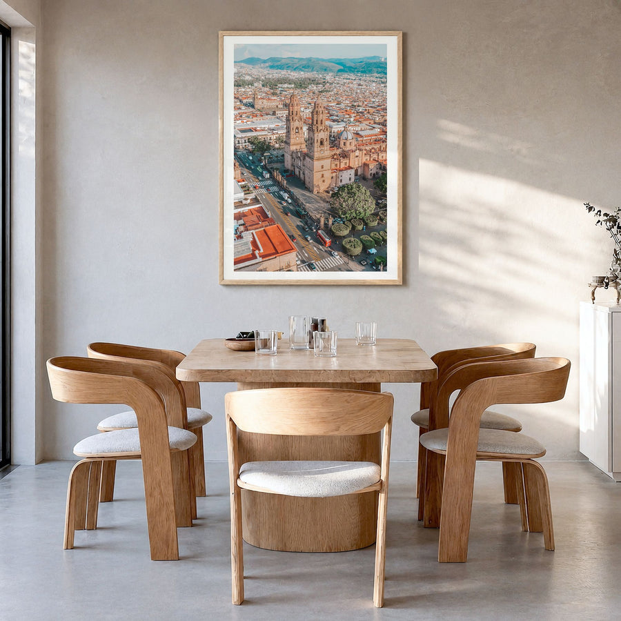 Morelia Photo Poster in a natural wood frame, hanging in a dining room, white border