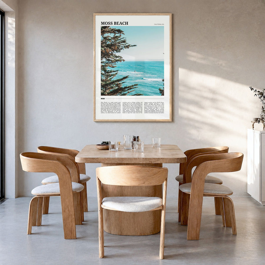 Moss Beach Travel Poster in a natural wood frame, hanging in a dining room