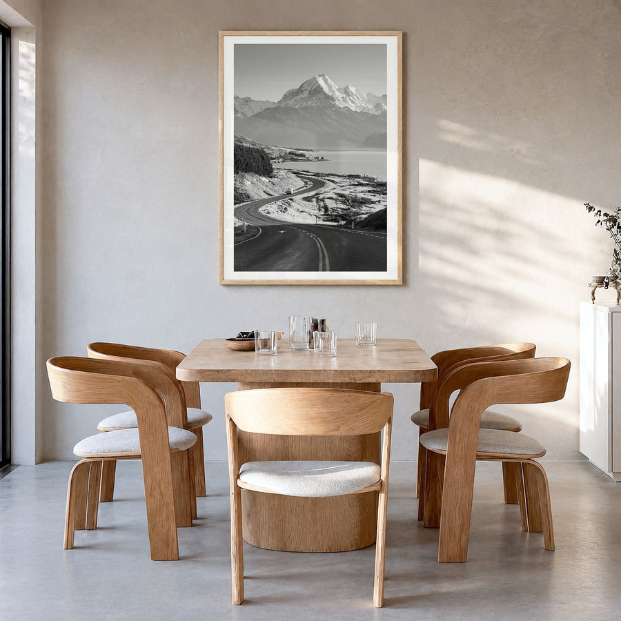Mount Cook Photo Poster in a natural wood frame, hanging in a dining room, white border