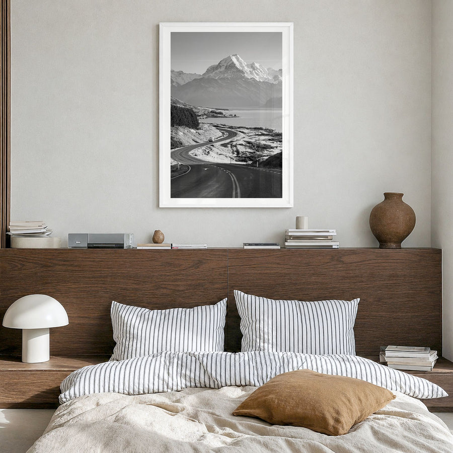 Mount Cook Photo Poster in a white wood frame, hanging in a bedroom, white border