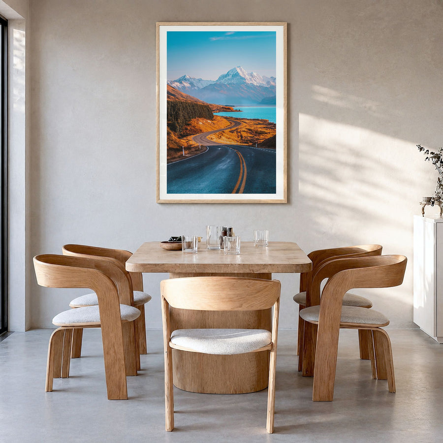 Mount Cook Photo Poster in a natural wood frame, hanging in a dining room, white border