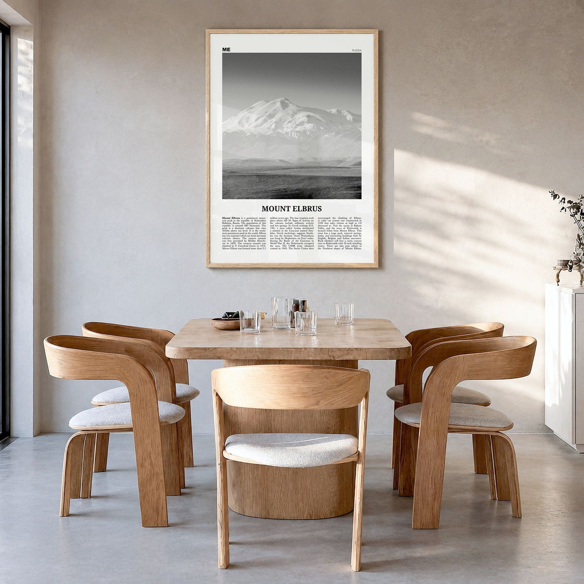 Mount Elbrus Newspaper Poster in a natural wood frame, hanging in a dining room