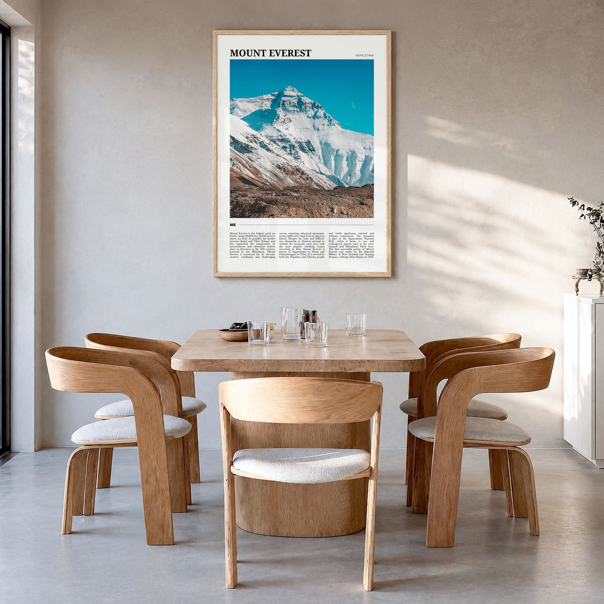 Mount Everest Travel Poster in a natural wood frame, hanging in a dining room