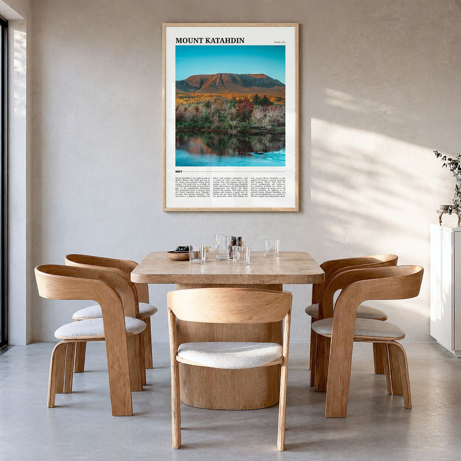 Mount Katahdin Travel Poster in a natural wood frame, hanging in a dining room