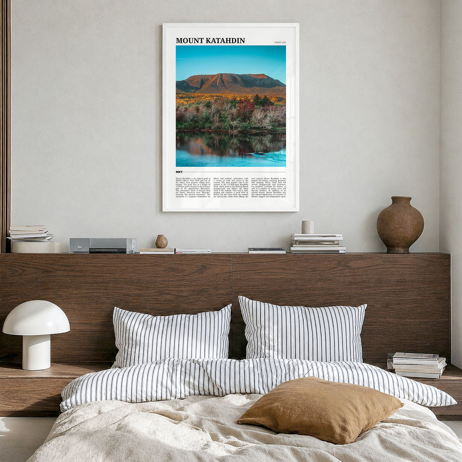 Mount Katahdin Travel Poster in a white wood frame, hanging in a bedroom